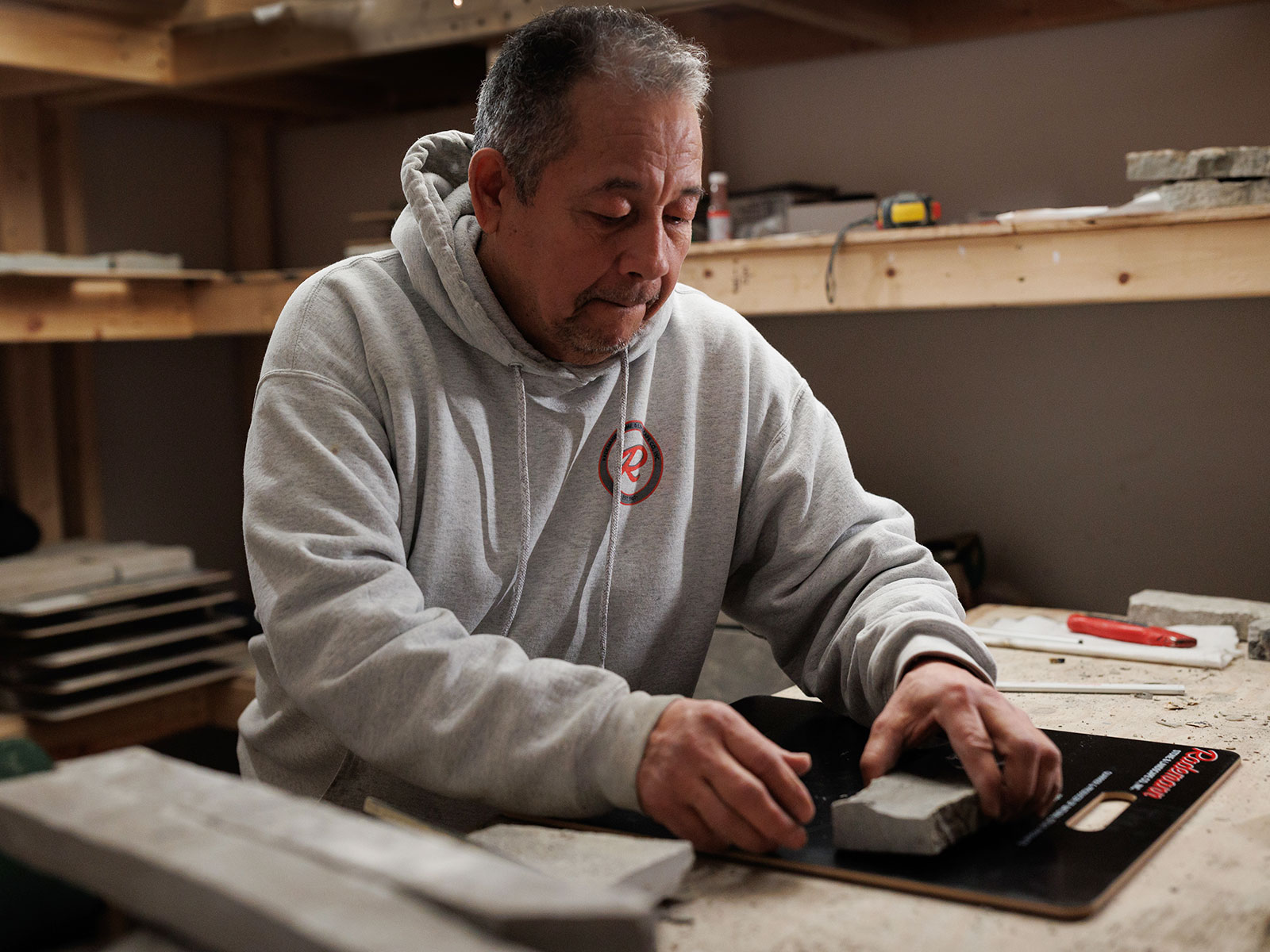 A Rademann Stone employee preparing a sample board of stone