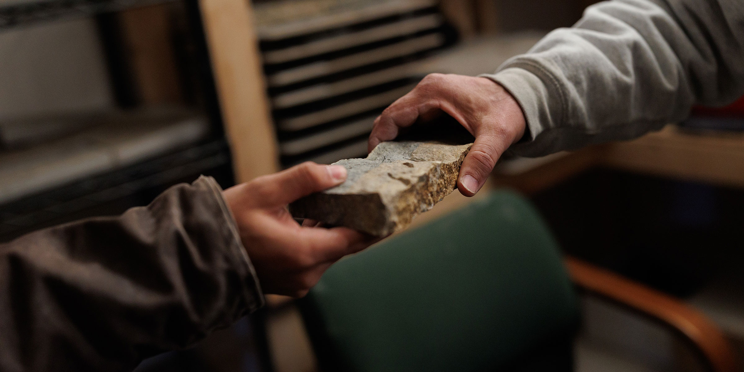 Close up of a Rademann stone being handed from one person to another