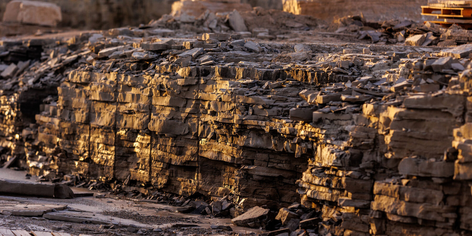 Stone wall illuminated by early morning sunlight in the Rademann Stone quarry
